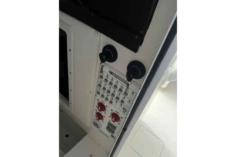 Slide: The Image of Control panel of 2024 Contender 32 ST boat with switches and dials. - 9