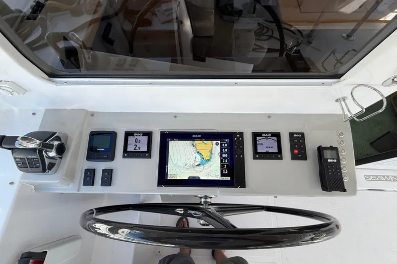 Slide: The Image of 2024 Seawind 1370 yacht cockpit with navigation controls and display screens. - 11