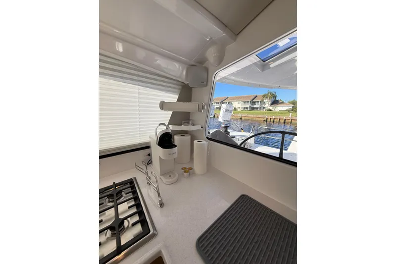 Slide: The Image of Modern kitchen interior of 2024 Seawind 1370 yacht with stove and coffee maker. - 12