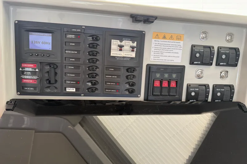 Slide: The Image of Electrical control panel of 2024 Seawind 1370 yacht, featuring switches and power indicators. - 15