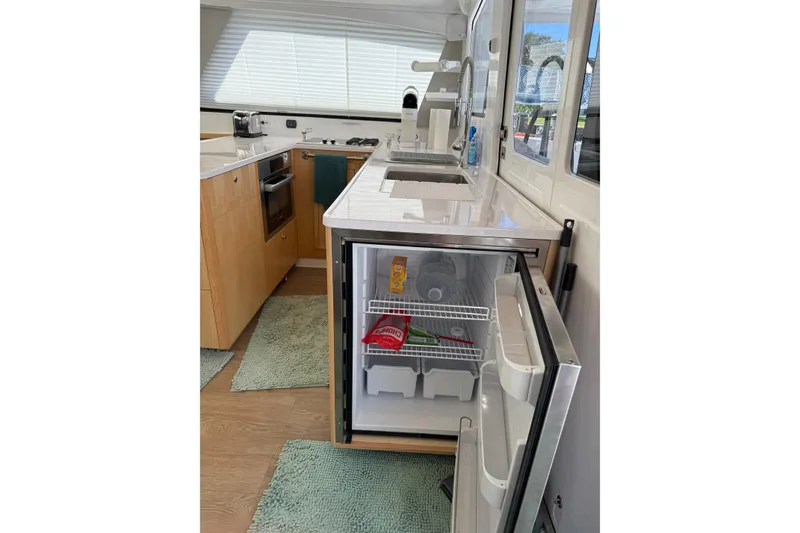 Slide: The Image of Modern kitchen in 2024 Seawind 1370 yacht with open fridge and sleek design. - 20