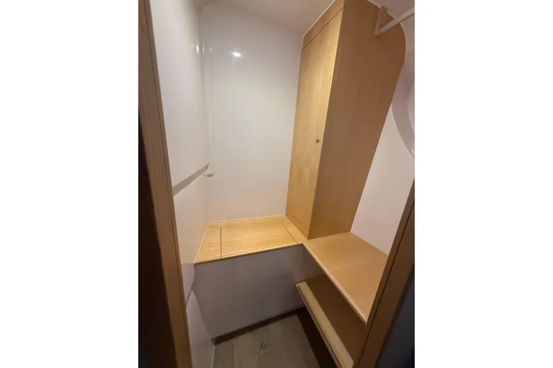 Slide: The Image of 2024 Seawind 1370 interior closet with wooden shelves and storage space. - 33