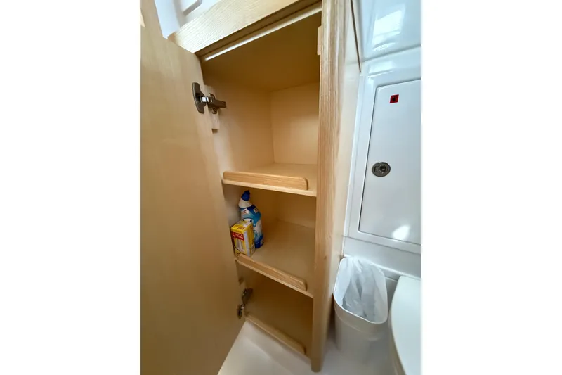 Slide: The Image of Open wooden cabinet with shelves in 2024 Seawind 1370 yacht bathroom. - 39