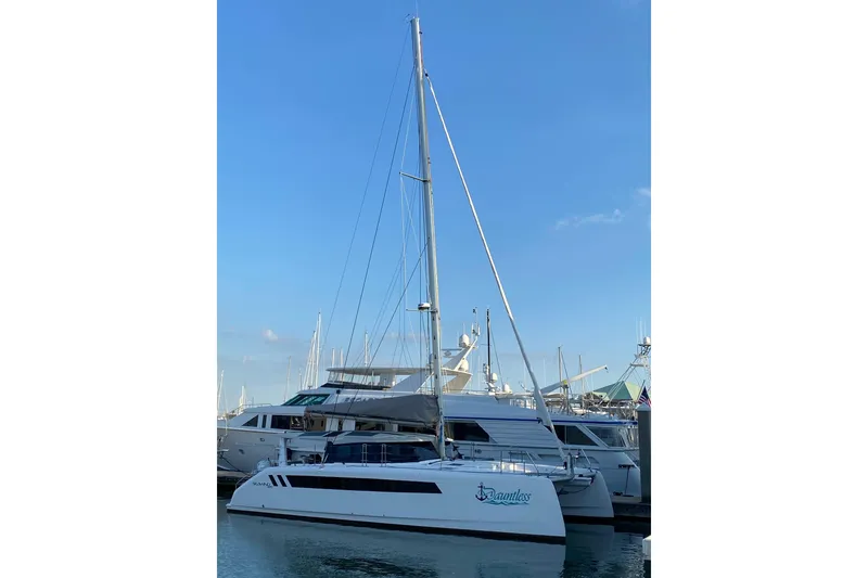 Slide: The Image of 2024 Seawind 1370 catamaran docked at marina under clear blue sky. - 4