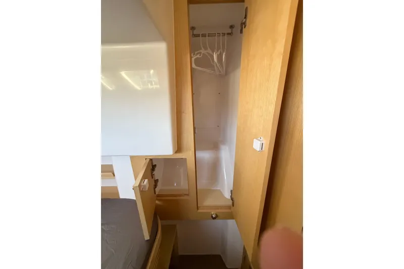 Slide: The Image of 2024 Seawind 1370 interior closet with wooden finish and hangers. - 43