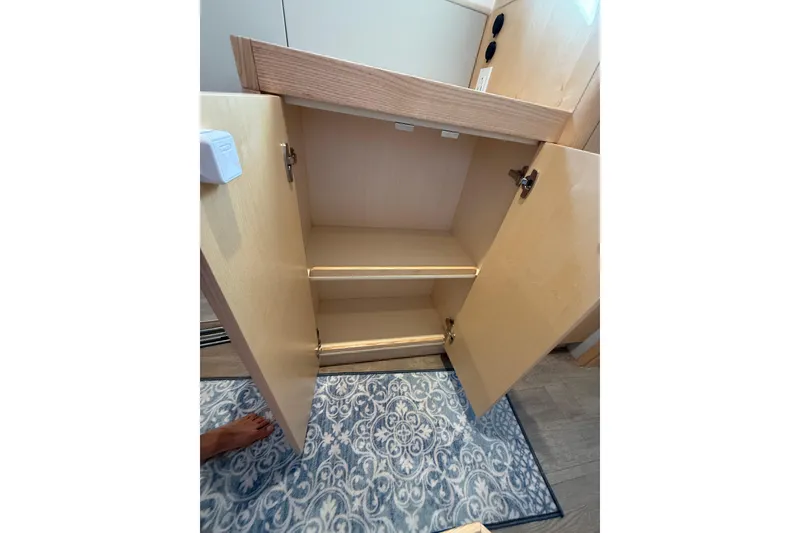 Slide: The Image of Open cabinet with shelves inside a 2024 Seawind 1370 boat interior. - 46