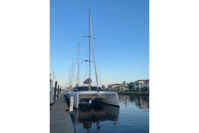 Slide: The Image of 2024 Seawind 1370 catamaran docked at marina, clear sky background. - 5