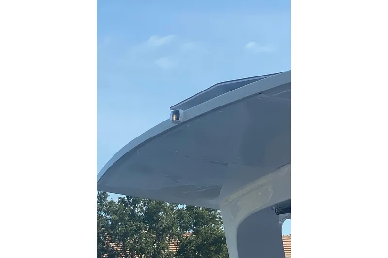 Slide: The Image of 2024 Seawind 1370 yacht detail against blue sky and trees. - 57