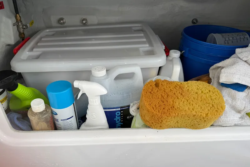 Slide: The Image of Cleaning supplies and sponge in storage on 2024 Seawind 1370 boat. - 81