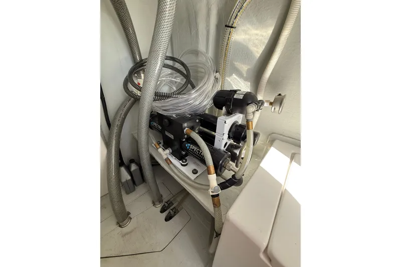 Slide: The Image of 2024 Seawind 1370 yacht interior with water filtration system and hoses. - 86