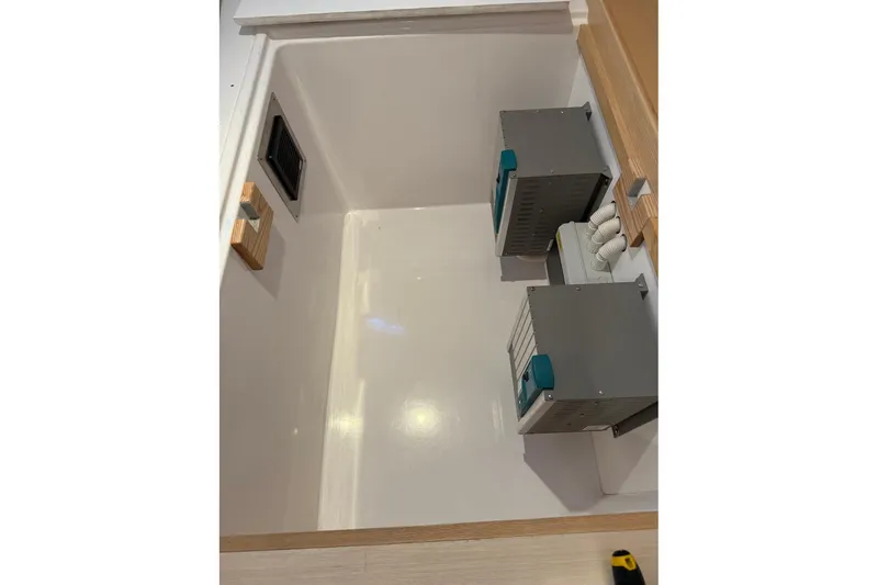 Slide: The Image of 2024 Seawind 1370 interior compartment with electrical components and wiring. - 87