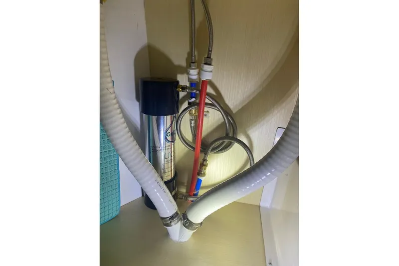 Slide: The Image of Plumbing system inside 2024 Seawind 1370 yacht, featuring hoses and connections. - 91