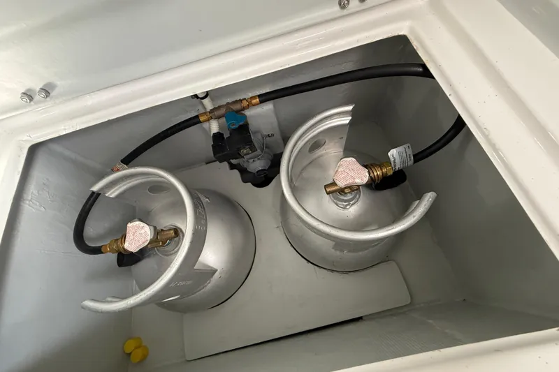Slide: The Image of Propane storage compartment on 2024 Seawind 1370 yacht, featuring two silver gas cylinders. - 92