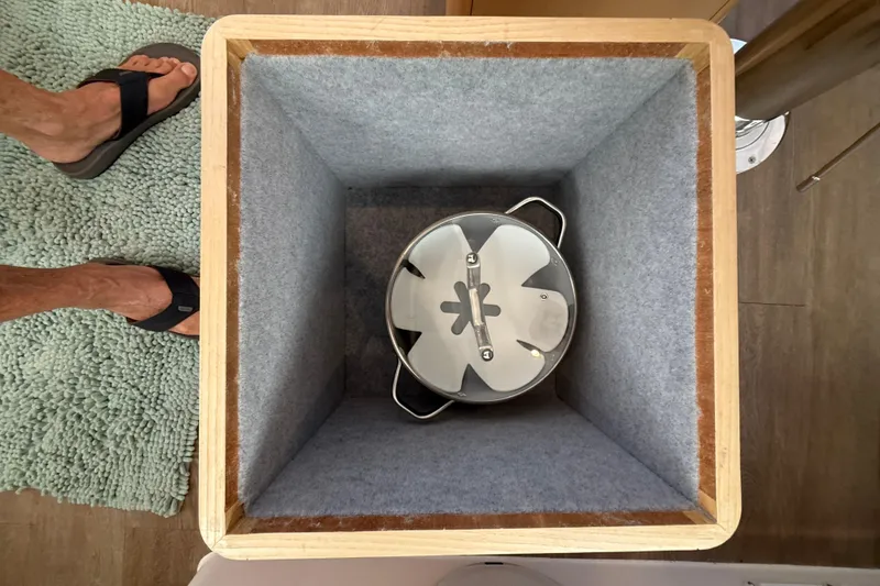 Slide: The Image of Interior view of Seawind 1370 (2024) with a pot in a lined storage compartment. - 94