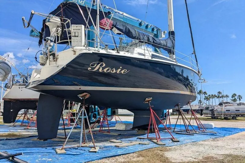 The Image of Hunter Vision 36 sailboat from 1993 named "Rosie" on stands in a boatyard. - 0