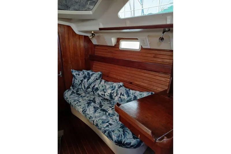 Slide: The Image of Interior of 1993 Hunter Vision 36 sailboat with floral-patterned seating and wooden accents. - 10