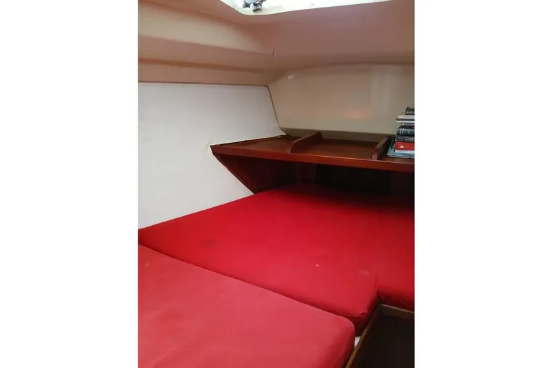Slide: The Image of Interior cabin of 1993 Hunter Vision 36 sailboat with red cushions and wooden shelves. - 15