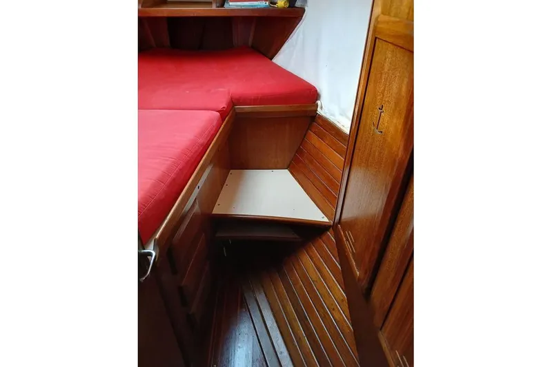 Slide: The Image of Interior of 1993 Hunter Vision 36 sailboat with red cushions and wooden cabinetry. - 16