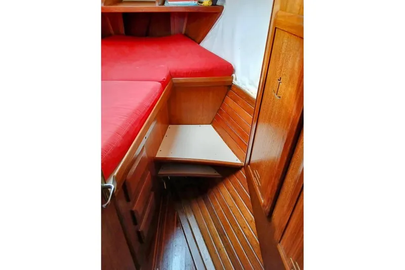 Slide: The Image of Interior of 1993 Hunter Vision 36 sailboat with red cushions and wooden cabinetry. - 18