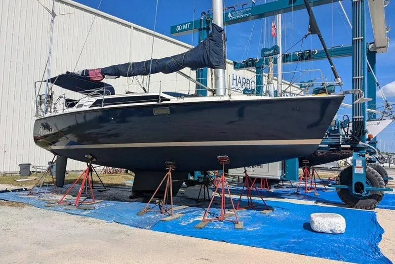 Slide: The Image of Hunter Vision 36 sailboat from 1993 on stands in a boatyard. - 2