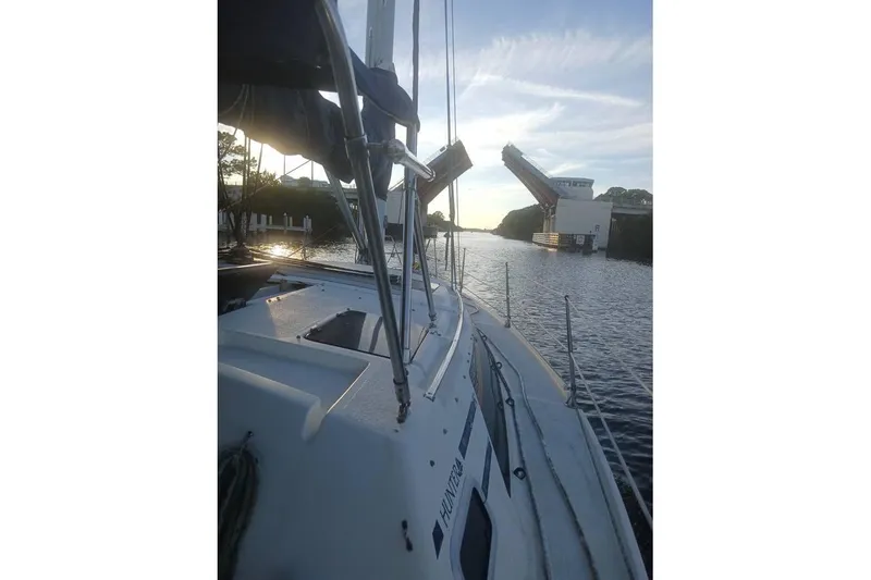 Slide: The Image of Sailboat "Hunter Vision 36" passing under an open drawbridge at sunset, 1993 model. - 5