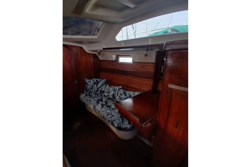 Slide: The Image of Cozy cabin interior of 1993 Hunter Vision 36 sailboat with wooden furnishings and floral bedding. - 9