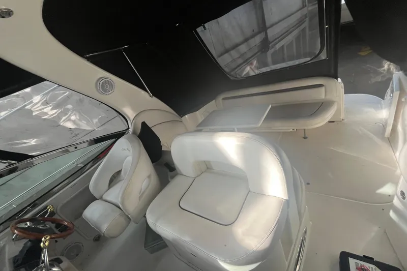 Slide: The Image of 2005 Sea Ray 360 Sundancer interior with white seating and steering wheel. - 11