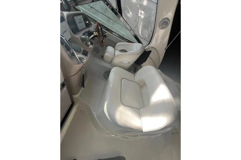 Slide: The Image of 2005 Sea Ray 360 Sundancer interior with seating and table, under a black canopy. - 12