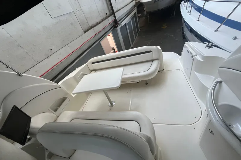 Slide: The Image of 2005 Sea Ray 360 Sundancer cockpit with white seating and control panel. - 13