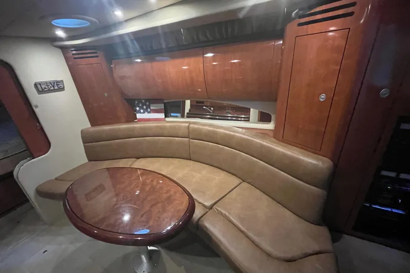 Slide: The Image of Interior of 2005 Sea Ray 360 Sundancer with leather seating and wooden table. - 19