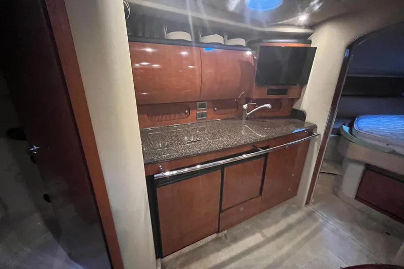 Slide: The Image of Luxurious interior of 2005 Sea Ray 360 Sundancer with curved seating and wooden table. - 20