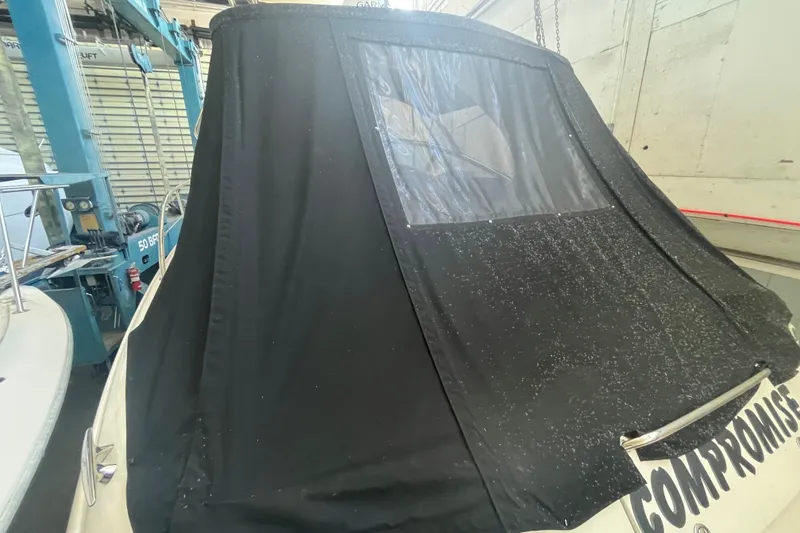 Slide: The Image of 2005 Sea Ray 360 Sundancer with black canvas cover in a boatyard. - 3