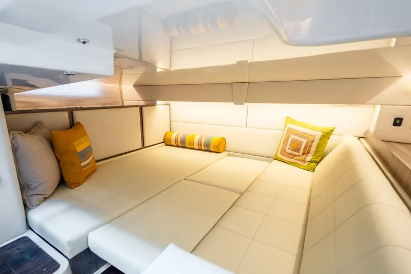 Slide: The Image of Luxurious interior of 2022 Regal 36 Grande Coupe with plush seating and decorative pillows. - 24