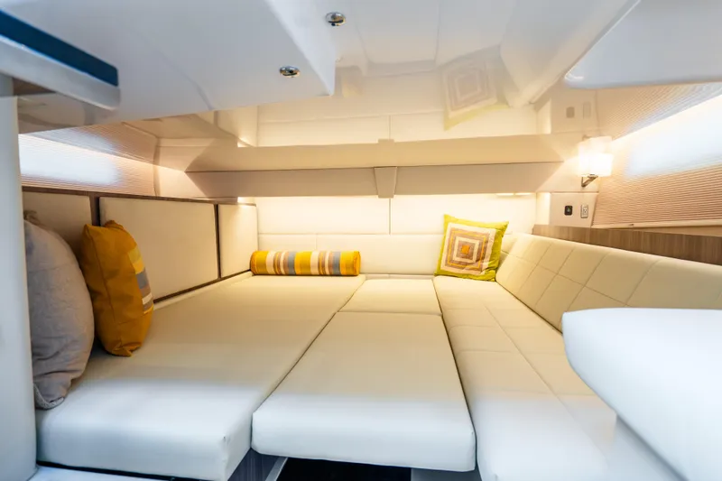 Slide: The Image of Luxurious interior of 2022 Regal 36 Grande Coupe with plush seating and decorative pillows. - 25