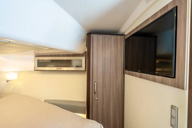 Slide: The Image of Interior cabin of 2022 Regal 36 Grande Coupe with TV and wooden cabinetry. - 30