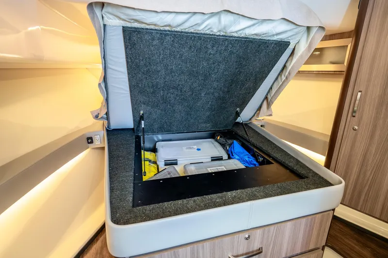 Slide: The Image of Under-bed storage compartment in 2022 Regal 36 Grande Coupe yacht interior. - 31