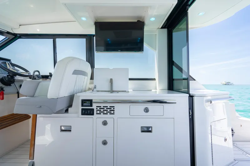 Slide: The Image of Interior of 2022 Regal 36 Grande Coupe yacht with modern helm and cabinetry. - 36