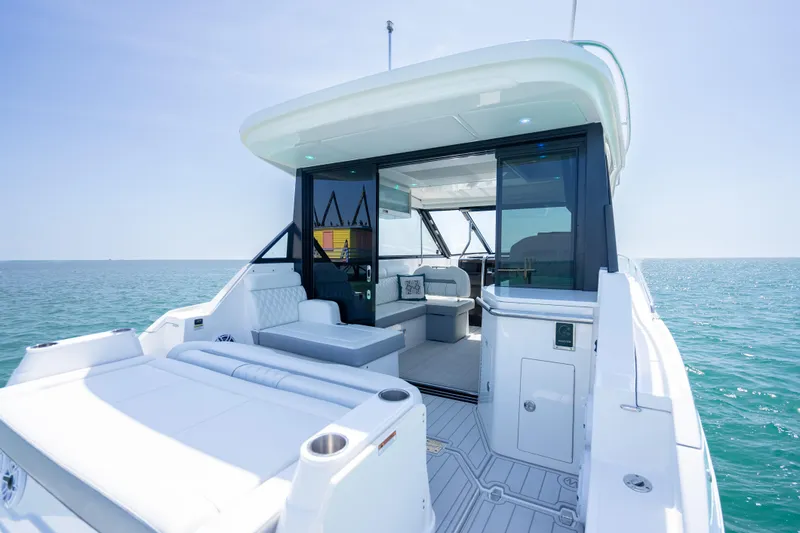 Slide: The Image of 2022 Regal 36 Grande Coupe yacht interior with ocean view, featuring sleek design and luxury seating. - 43