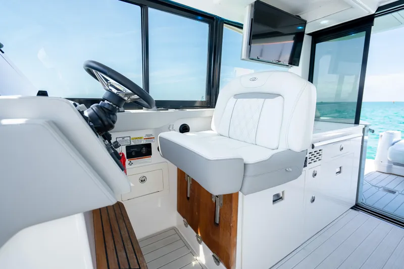 Slide: The Image of Interior of 2022 Regal 36 Grande Coupe boat with helm and luxurious seating. - 49