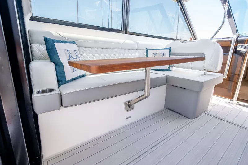 Slide: The Image of Luxurious interior seating of 2022 Regal 36 Grande Coupe yacht with elegant cushions and table. - 72