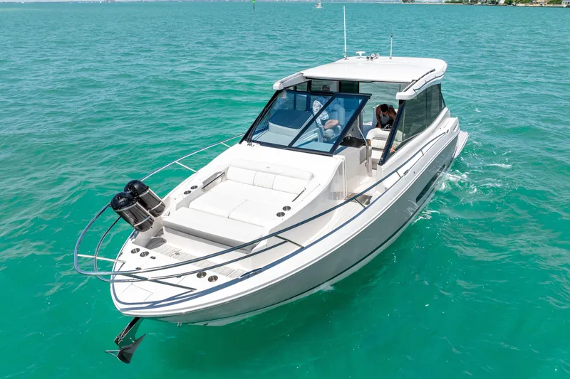 Slide: The Image of 2022 Regal 36 Grande Coupe cruising on turquoise waters. - 8