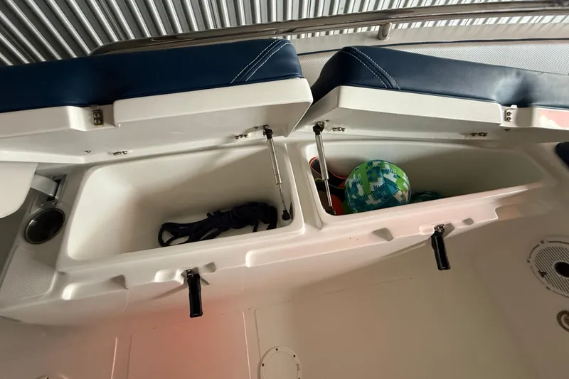 Slide: The Image of 2023 AB Inflatables Nautilus 17 DLX storage compartments with blue seats and accessories. - 13