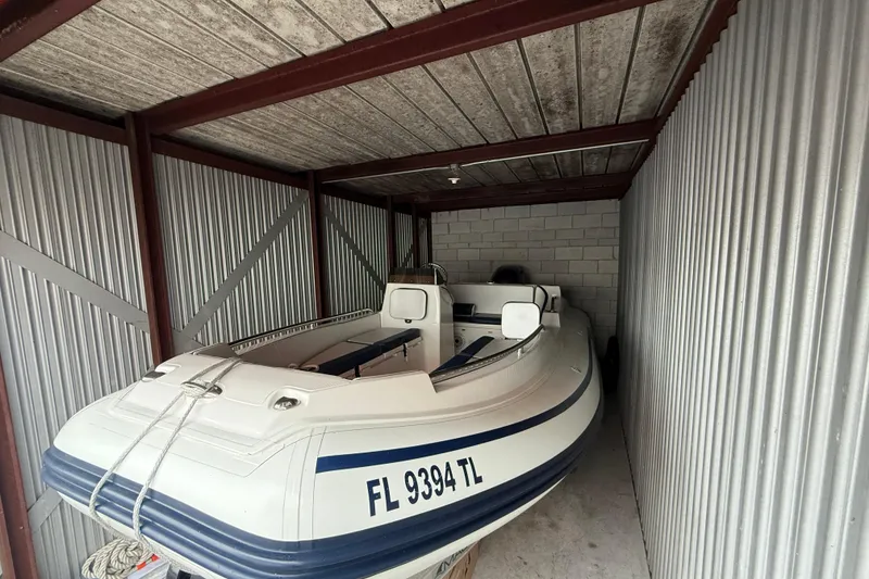 Slide: The Image of 2023 AB Inflatables Nautilus 17 DLX boat stored in a metal shed. - 3