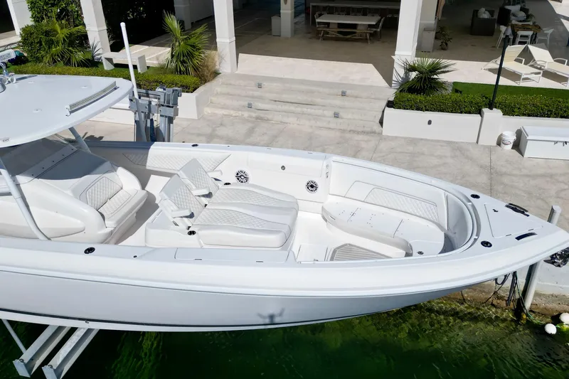 Slide: The Image of 2024 Intrepid 407 Nomad FE boat docked, showcasing sleek design and luxurious seating. - 11
