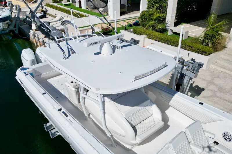 Slide: The Image of 2024 Intrepid 407 Nomad FE boat docked, featuring sleek design and advanced equipment. - 12