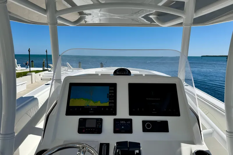Slide: The Image of 2024 Intrepid 407 Nomad FE boat dashboard with ocean view in background. - 20