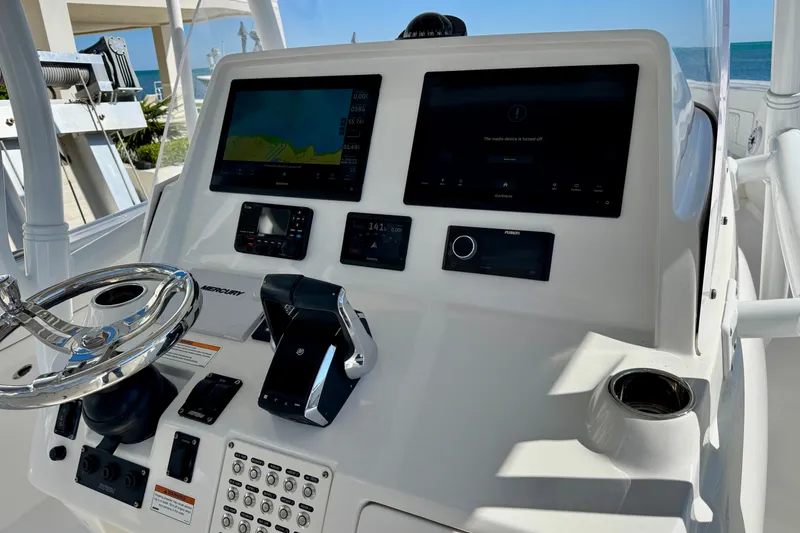 Slide: The Image of 2024 Intrepid 407 Nomad FE boat dashboard with advanced navigation and control systems. - 21