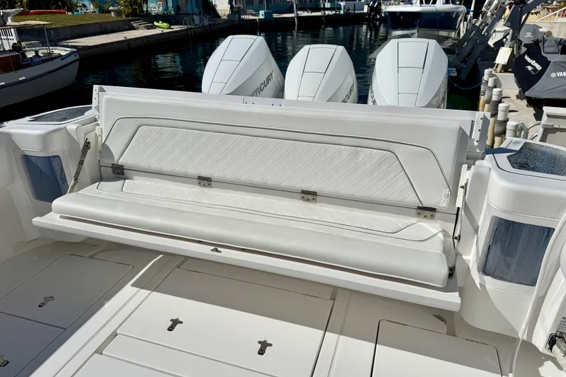 Slide: The Image of 2024 Intrepid 407 Nomad FE boat with luxurious seating and powerful engines docked. - 25