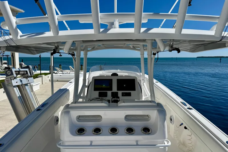 Slide: The Image of 2024 Intrepid 407 Nomad FE boat, featuring a sleek console and ocean backdrop. - 31