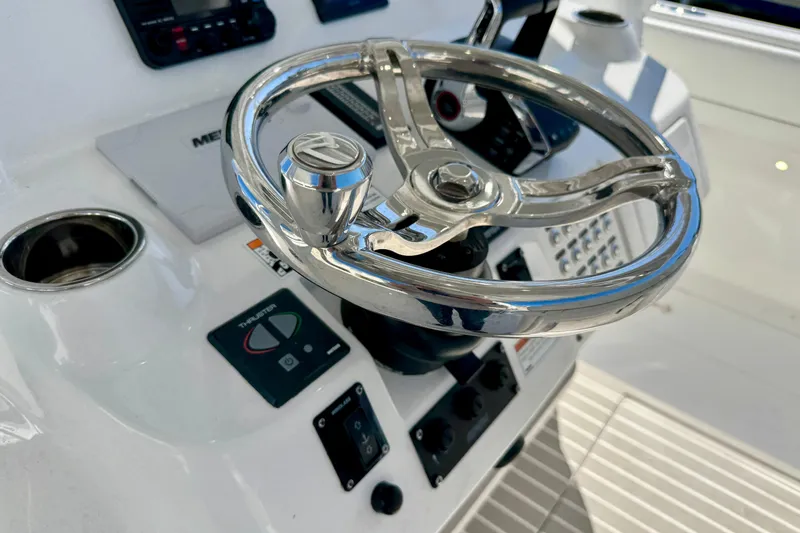 Slide: The Image of Steering wheel of 2024 Intrepid 407 Nomad FE boat, featuring modern controls and dashboard. - 32